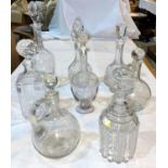 Ten various cut glass decanters