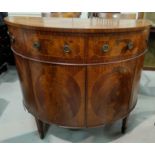 A period style demi-lune side cabinet in crossbanded and inlaid figured mahogany with 2 drawers