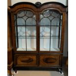 A 1920's mahogany display cabinet with double dome top, on cabriole legs