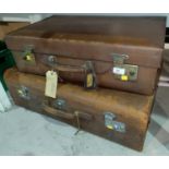 Two leather covered suitcases