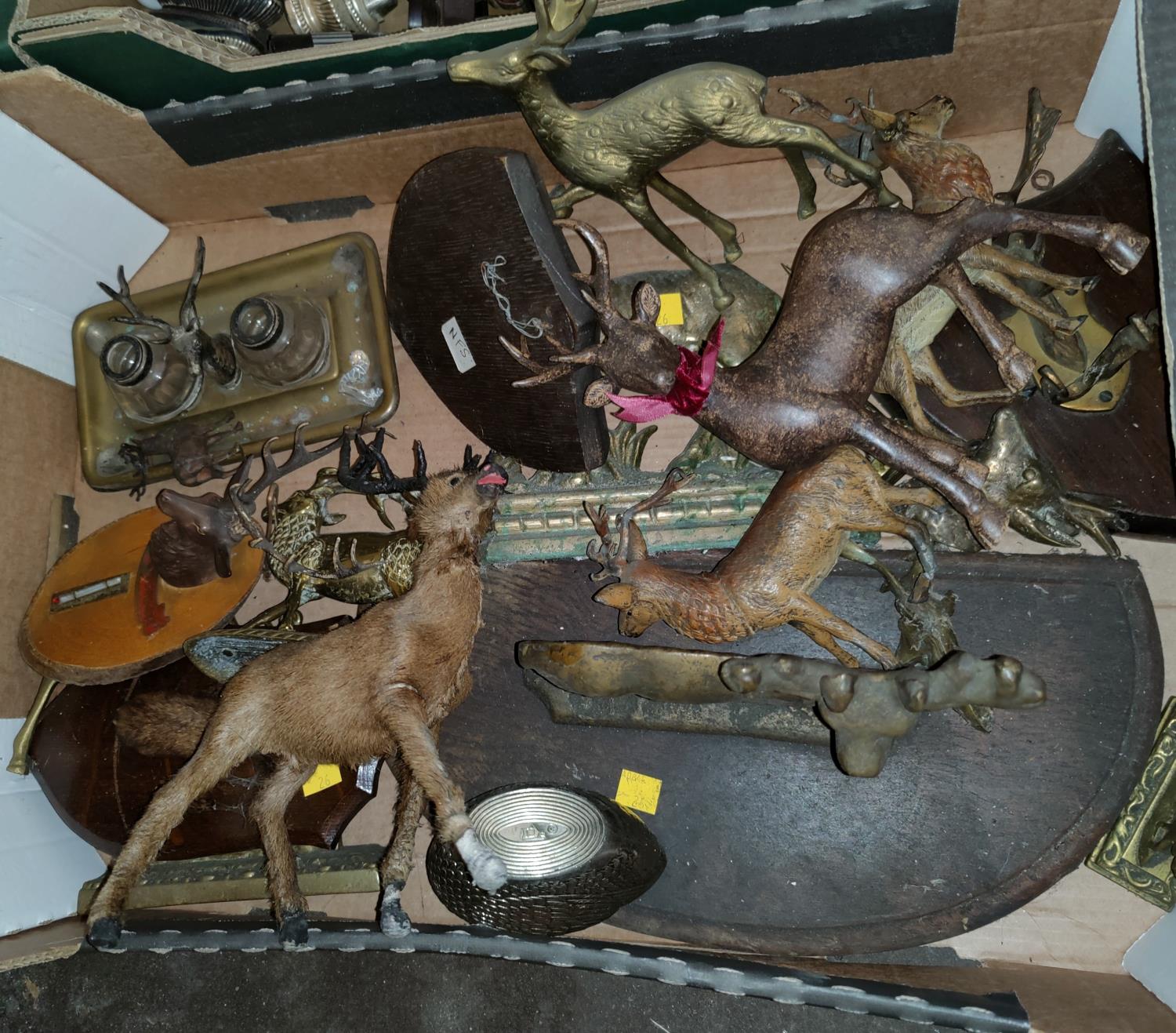 A brass figure of a stag and a selection of others similar