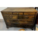 An antique stained pine chest of 7 graduated drawers, on ogee bracket feet, 133 cm