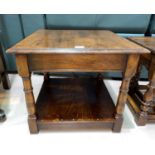 An Oak square coffee table with shelf under and turned legs