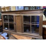 A 19th century Provincial oak wall hanging cupboard with glazed doors af