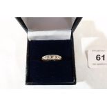An Edwardian five stone diamond ring. In gold marked 18ct. 3g gross. Size N
