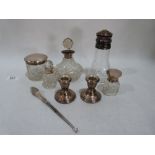 Four silver topped glass jars, a pair of silver squat candlesticks, a silver buttonhook and a silver