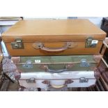 A vintage leather suitcase and two canvas cases