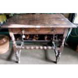 A 17th century joined oak side table, the moulded top over frieze drawer on turned supports with