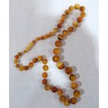 A necklace of graduated amber beads. 34.8g gross. 24' long