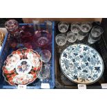 Two Imari plates, a copper warming plate, cranberry and other glassware