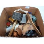 A box of sundries to include an African treen headrest, prayer wheel etc.