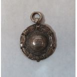 An RAF Lakenheath silver watch fob