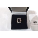 A sapphire and white stone cluster ring. In gold marked 585. 3.4g gross. Size S
