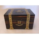 A Victorian coromandel two division tea caddy with applied brass strapwork, escutcheon and