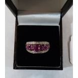 A ruby and white stone ring. In gold marked 9K. 3.1g gross. Size N