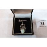 An Art-Deco style silver opal and marcasite pendant.