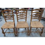 A set of three ladderback chairs with rush seats