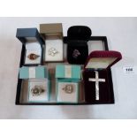 Five silver rings and a silver crucifix pendant