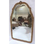 A parcel gilt framed looking glass with shaped bevelled plate. 28' high