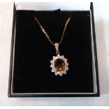 A 9ct oval citrine and white stone pendant on 9ct necklet chain. 3.5g gross