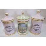 Three ceramic apothecary jars and covers, one decorated with a view of Buckingham Palace, the others