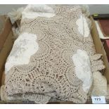 A lacework table cloth and a bedspread