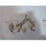 A silver articulated figural pendant, another pendant and a silver locket