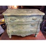 An apprentice bombe shaped commode, three drawer chest, original green paint and scroll handles.