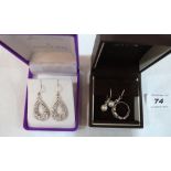 A silver white stone ring, a pair of white stone earrings and a pair of cultured pearl earrings