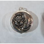 A silver fob pill box, the lid with Art-Nouveau repousse decoration. 1 1/8' diam