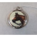 A white metal patch box pendant, the lid with a horse head in enamel and interior mirror