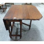 A 1920s oak gateleg table on barleytwist legs