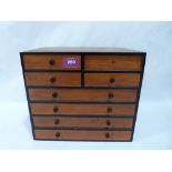 A miniature chest of eight drawers. 10' high