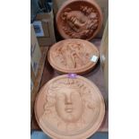 Two terracotta garden wall plaques
