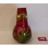 A Minton Secessionist vase, number 42, tube-line decorated with foliage on a red ground. Factory