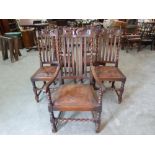 A set of five oak barleytwist dining chairs with leather drop-in seats, the set to include a carver