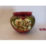 A Minton Secessionist pot, number 49, tube-line decorated with stylised foliage in shades of red,
