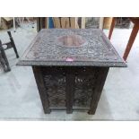 An oriental carved and pierced hardwood table. 23' wide