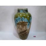 A Mintons secessionist ovoid vase, decorated with tube-lined blue flowers and foliage on a grey