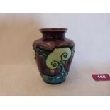 A Minton Secessionist vase, number 6, tube-line decorated with stylised foliage in shades of