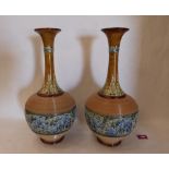 A pair of Doulton Lambeth ware vases, the body decorated with continuous band of blue flowers and