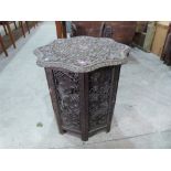 An oriental carved and pierced hardwood table. 26' diam