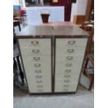 A pair of nine drawer metal filing cabinets