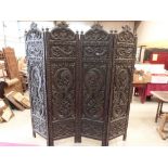 A 19th century carved hardwood four-fold screen. Indian or oriental. 84' high x 80'