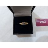 A diamond solitaire ring. In gold marked 750. 3.3g gross. Size P½