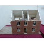 A dolls house in the form of a two bay Georgian dwelling. 28' wide