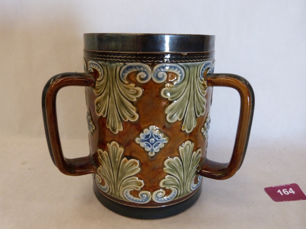 A Doulton Lambeth tyg with silver rim hallmarked Sheffield 1899, the body decorated by Jane Hurst