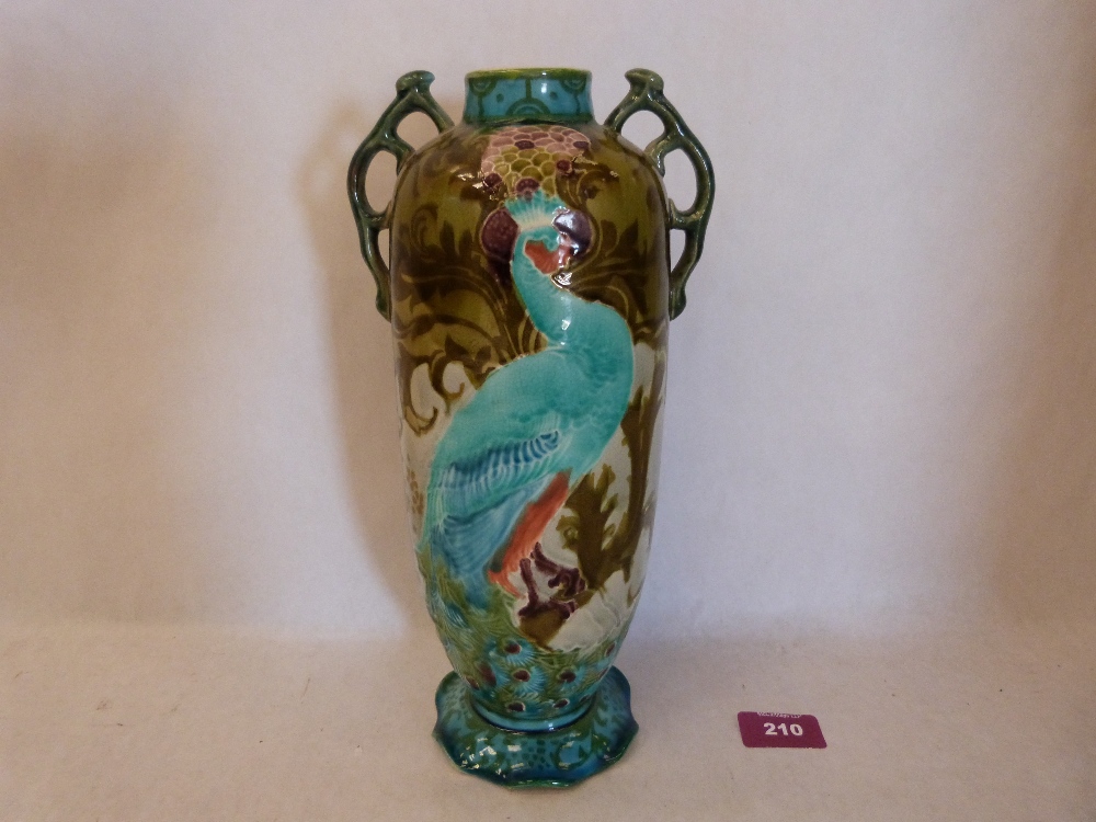 A Mintons ovoid two handled vase decorated in brightly coloured enamels with peafowl and foliage.