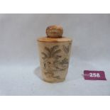 A Japanese bone snuff bottle, decorated with scenes of an erotic nature. 3½' high