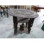 An oriental carved hardwood table. 30' wide. (A.F.)